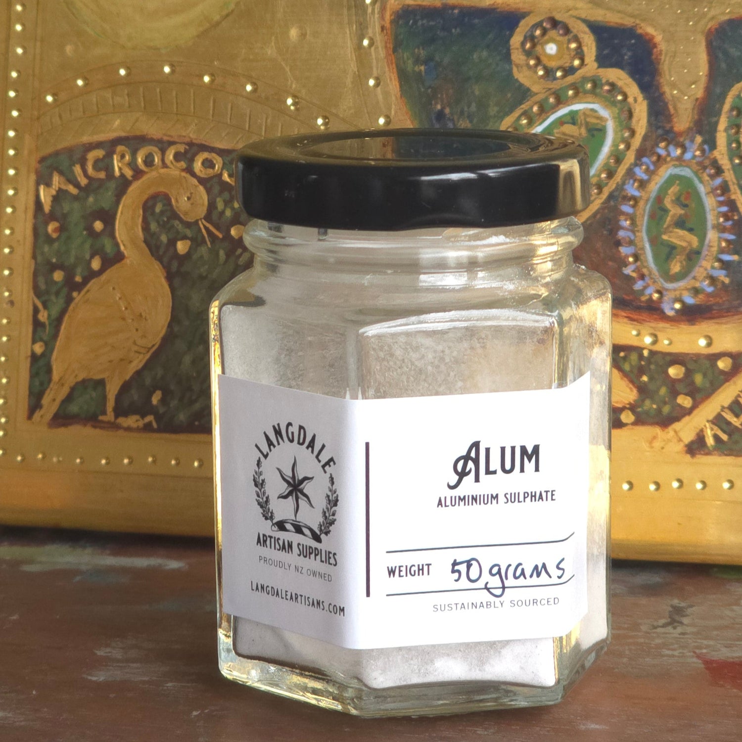 small glass jar with Alum in it